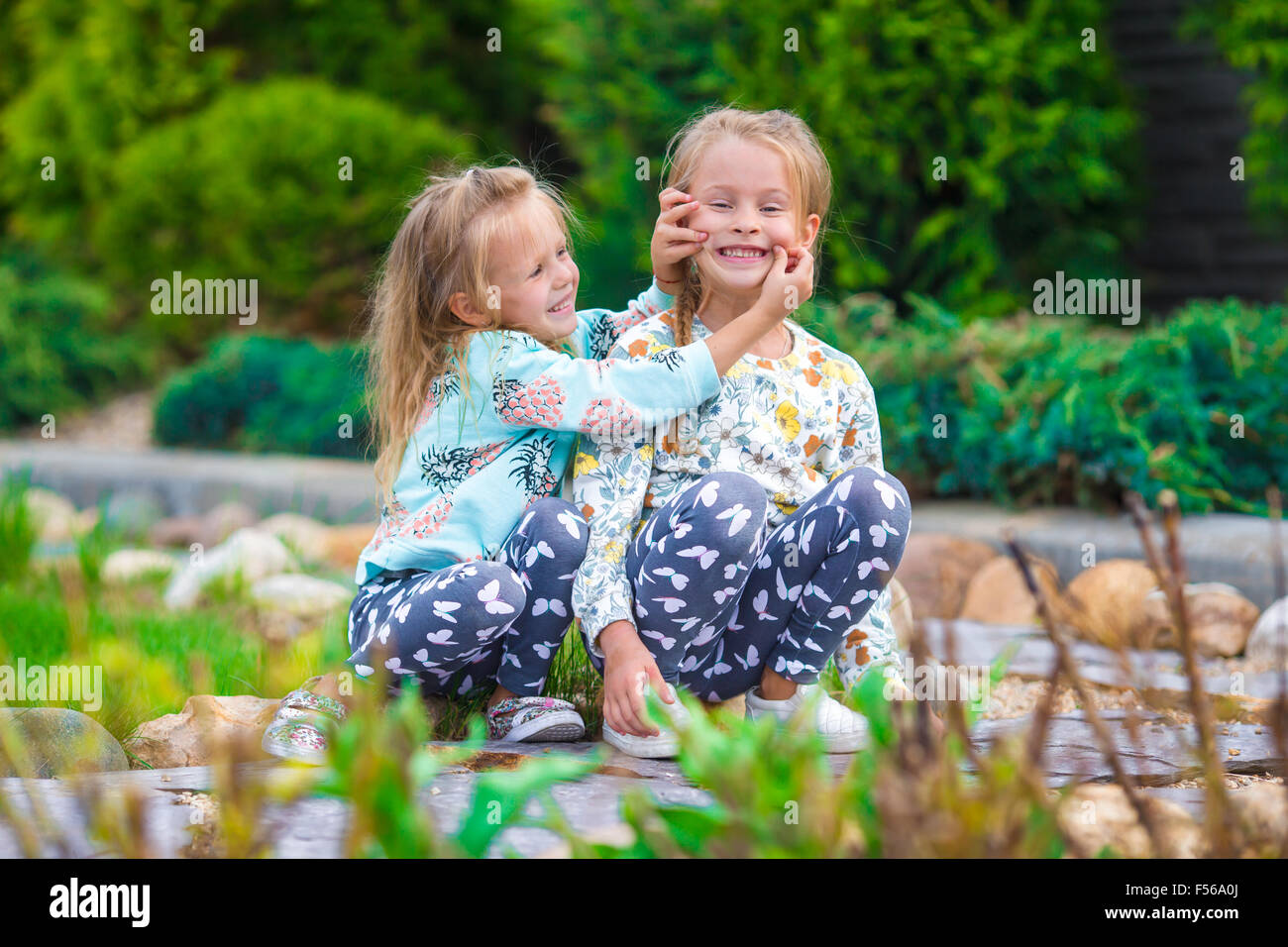 Little adorable girls at warm sunny autumn day outdoors Stock Photo - Alamy