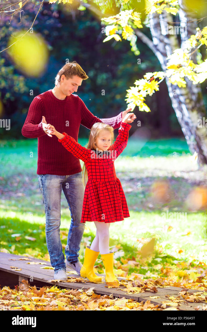 Adorable little girl with father have fun in autumn park outdoors Stock ...