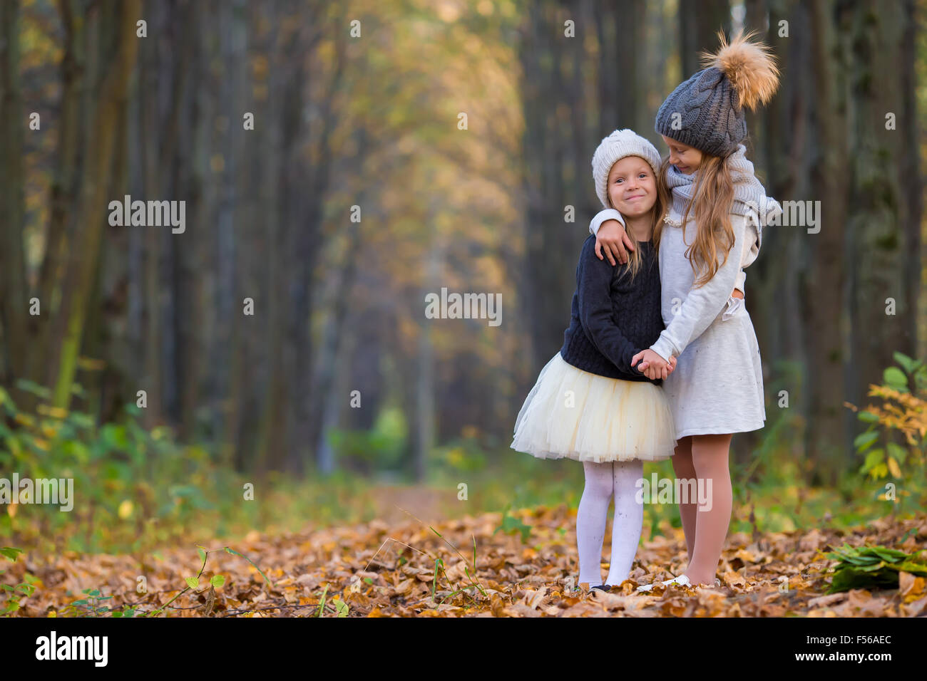 Little adorable girls outdoors at warm sunny autumn day Stock Photo - Alamy