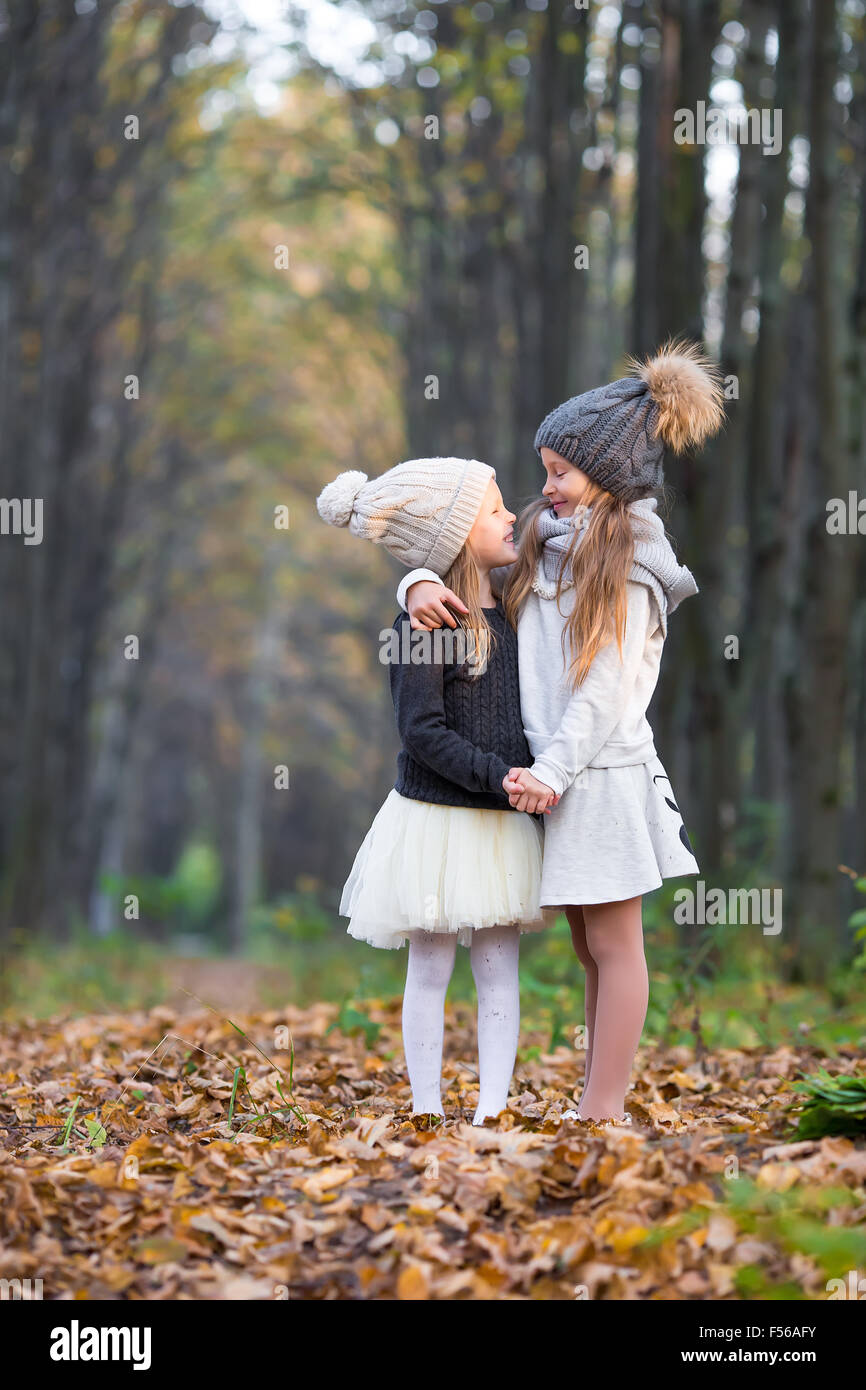 Little adorable girls outdoors at warm sunny autumn day Stock Photo - Alamy