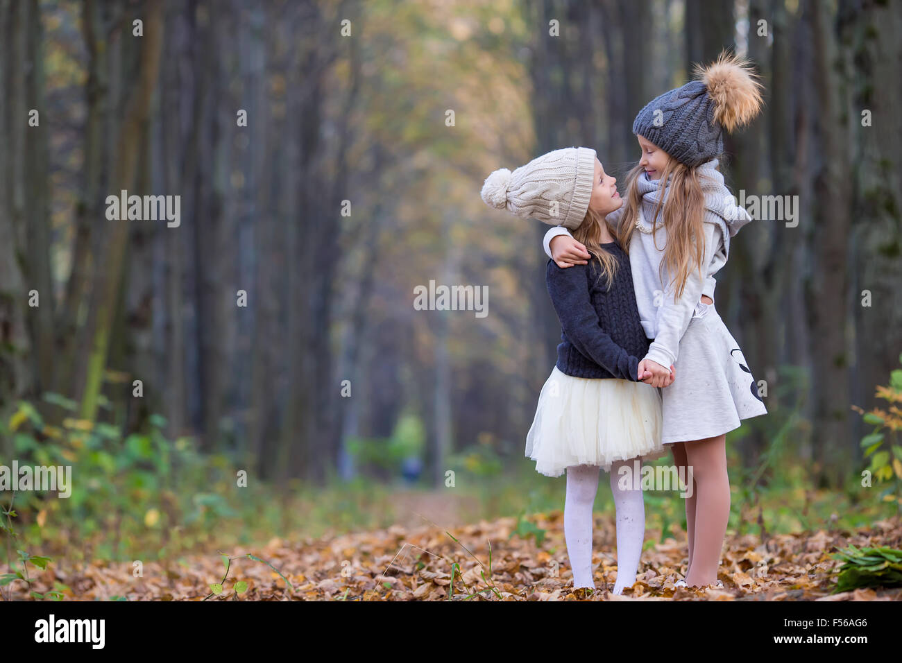 Little adorable girls outdoors at warm sunny autumn day Stock Photo - Alamy