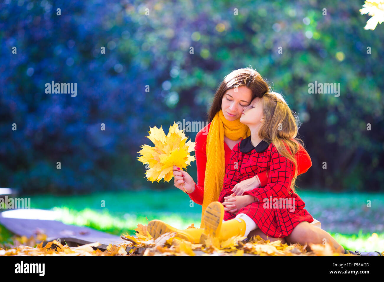 Adorable little girl with mother in autumn park outdoors Stock Photo ...