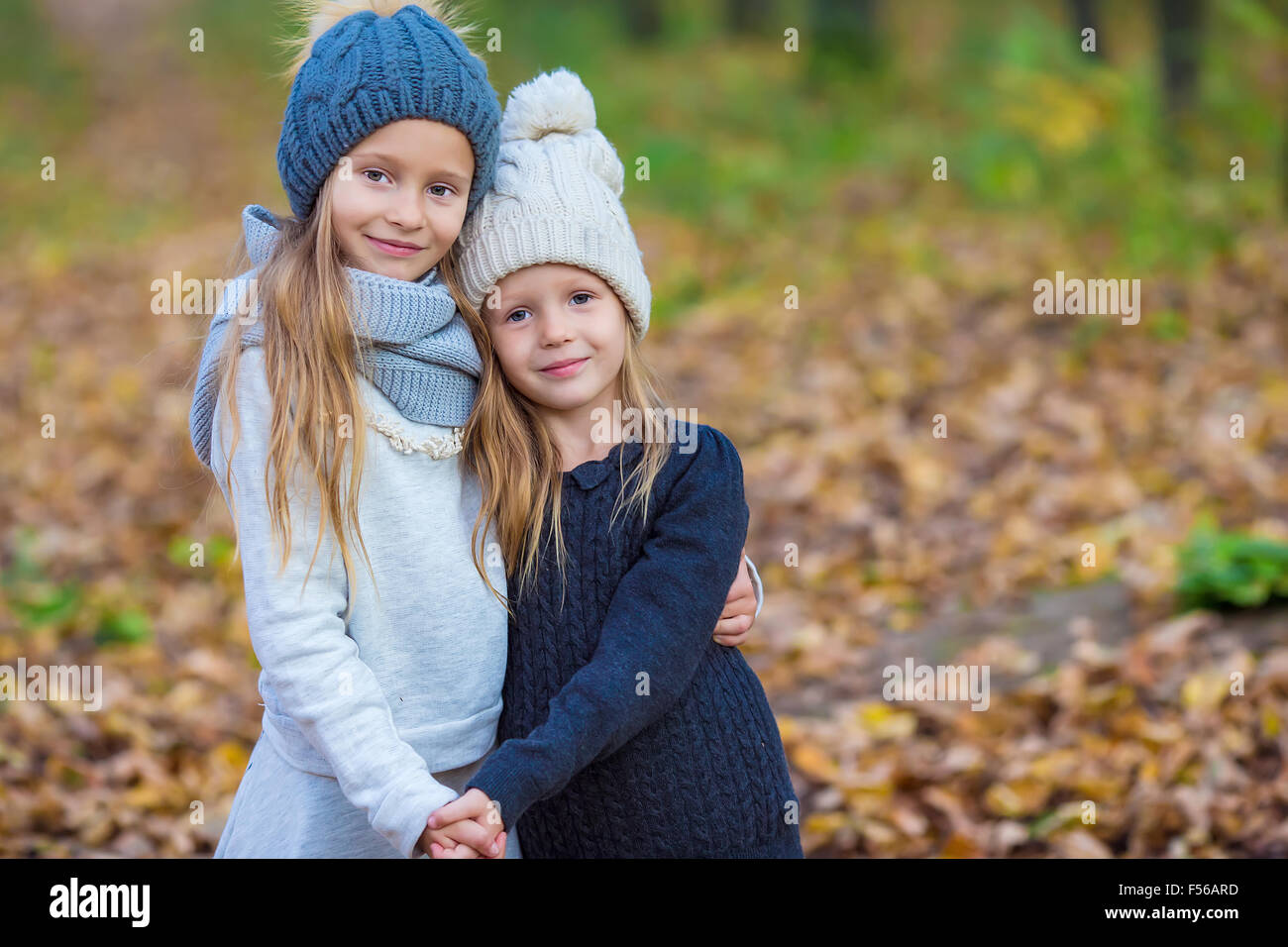 Little adorable girls outdoors at warm sunny autumn day Stock Photo - Alamy