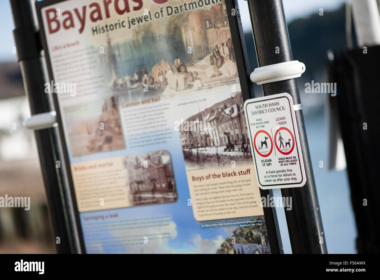 Dog fouling warning signs in the Devon riverside town of Dartmouth in Bayards Cove the historic jewel of the port Stock Photo