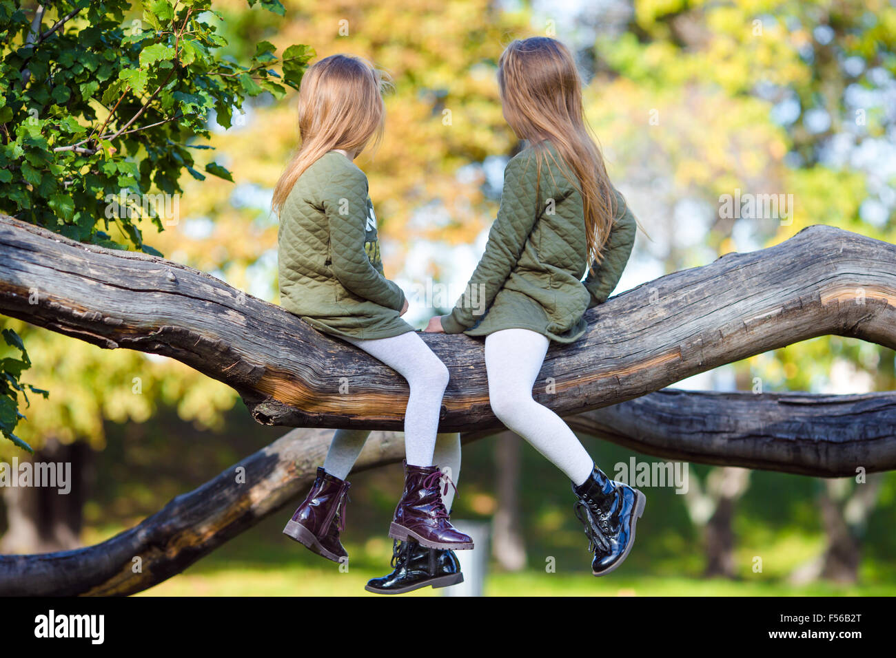 Little adorable girls outdoors at warm autumn day Stock Photo - Alamy