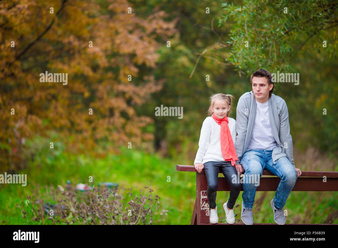 Little girl with happy dad in autumn park outdoors Stock Photo - Alamy