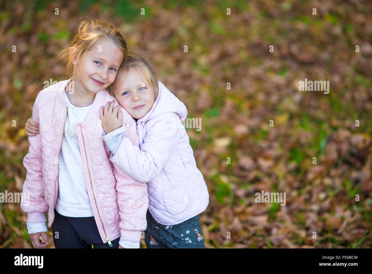 Little adorable girls outdoors at warm autumn day Stock Photo - Alamy