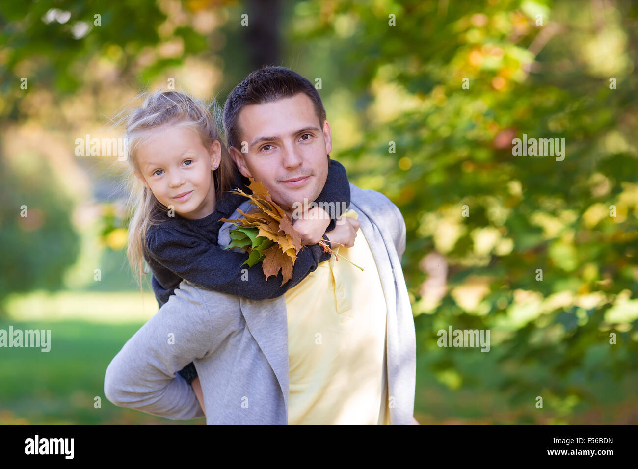 Little adorable girl with happy father in autumn park outdoors Stock ...