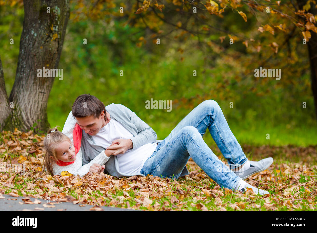 Happy family in autumn park outdoors Stock Photo - Alamy