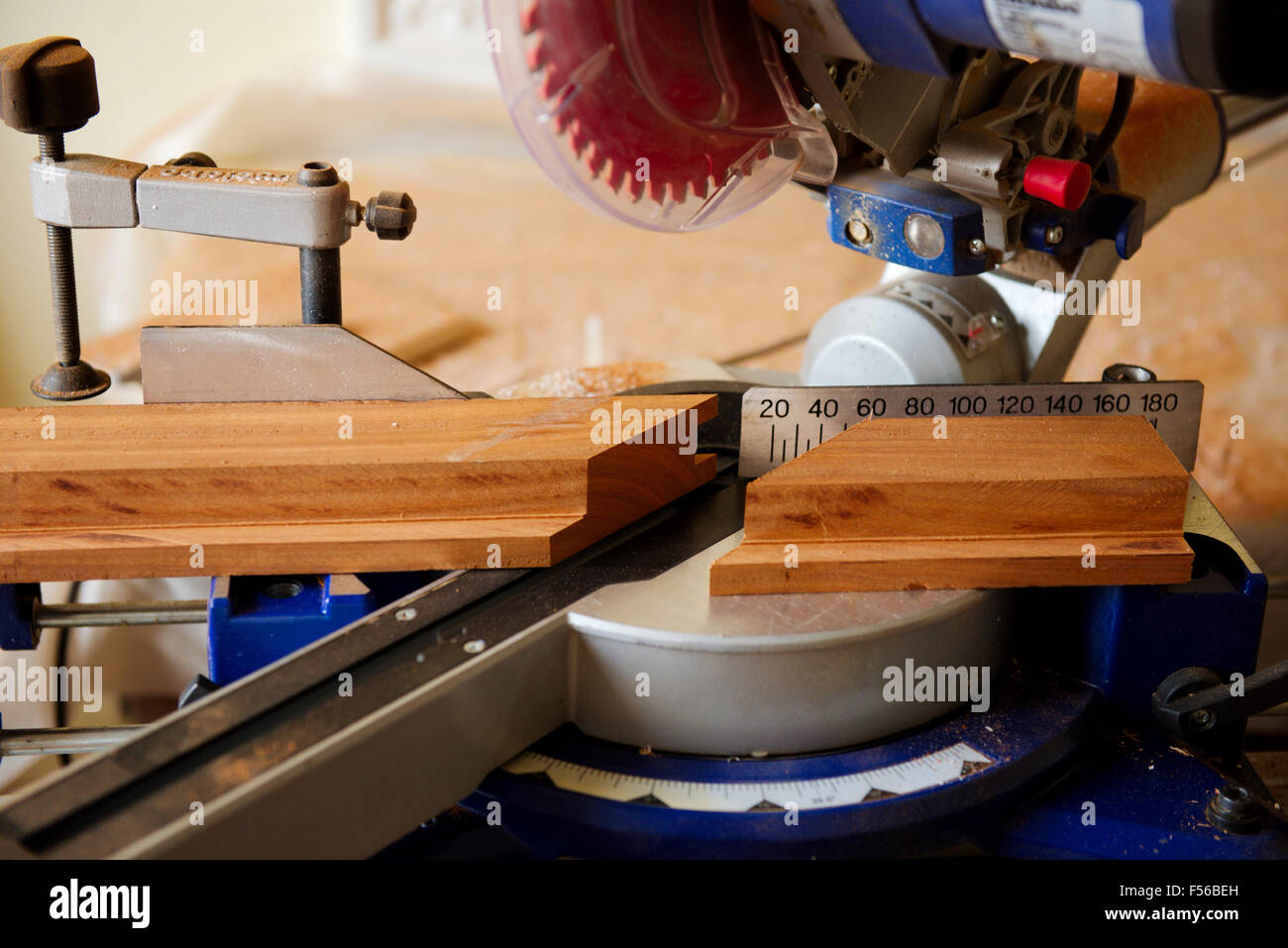 Sliding compound mitre circular saw cutting mitre in wood Stock Photo