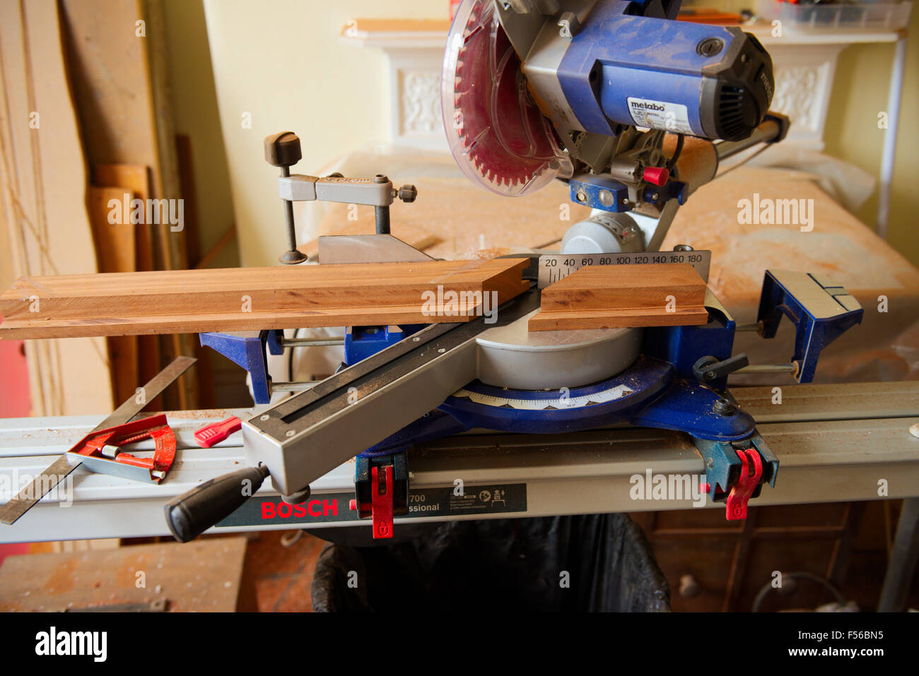 Sliding compound mitre circular saw on saw table cutting mitre in wood