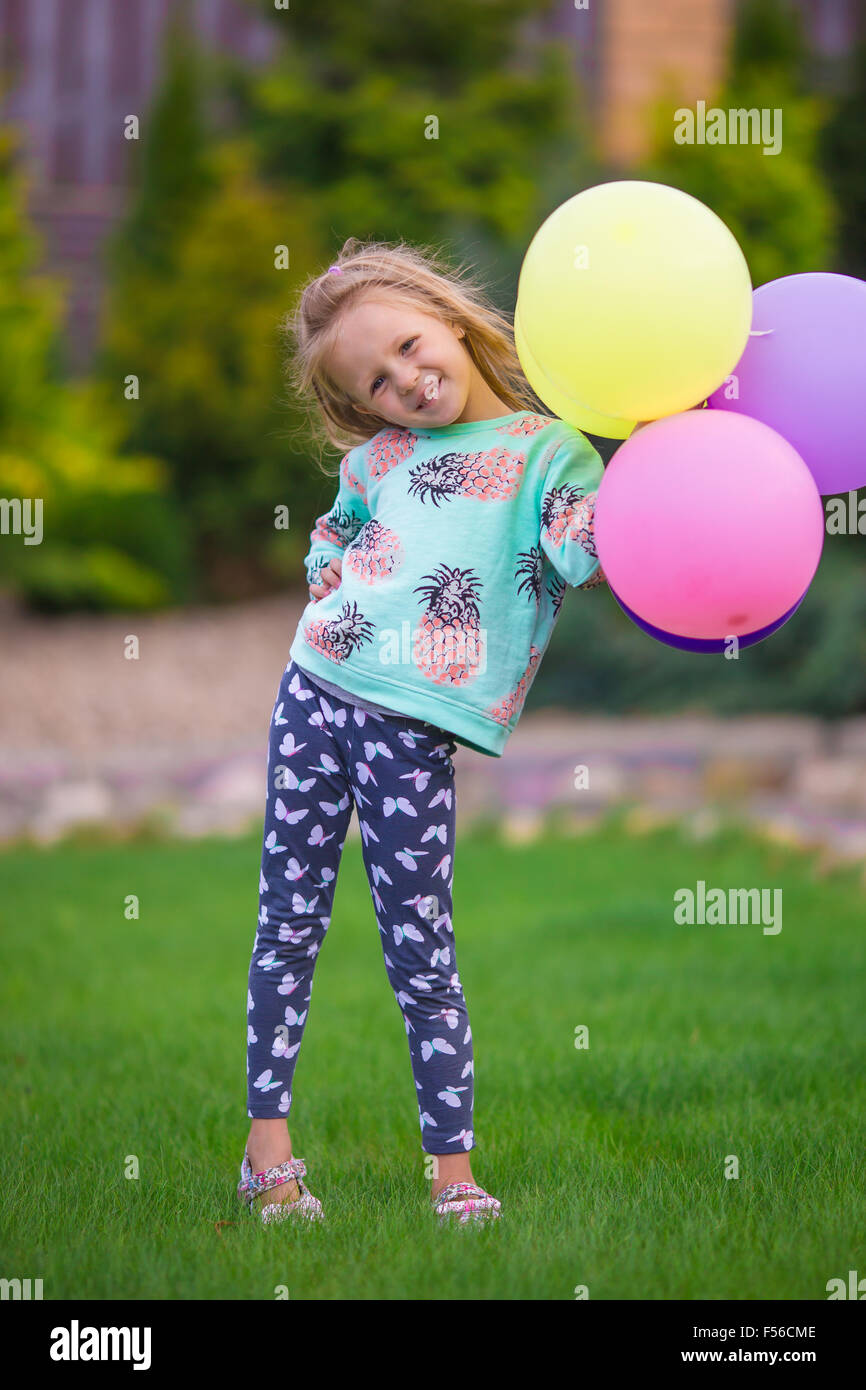Happy little girl playing with balloons outdoors Stock Photo - Alamy