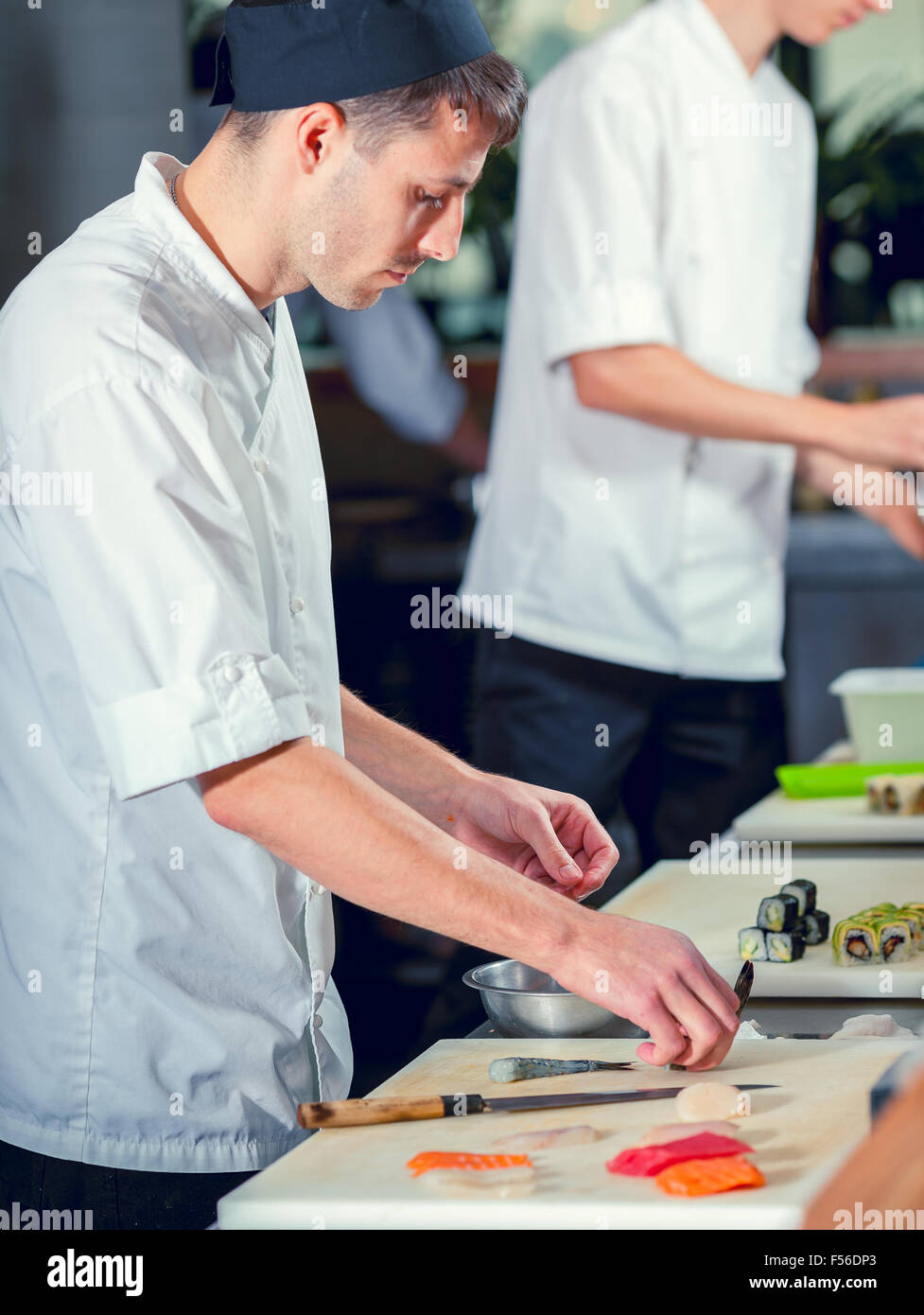 male cooks preparing sushi Stock Photo