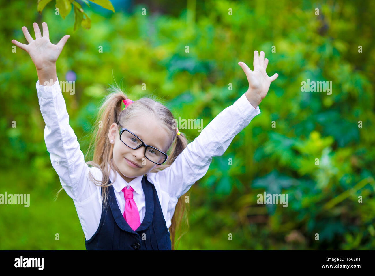 Portrait of adorable little school girl in glasses outdoor Stock Photo