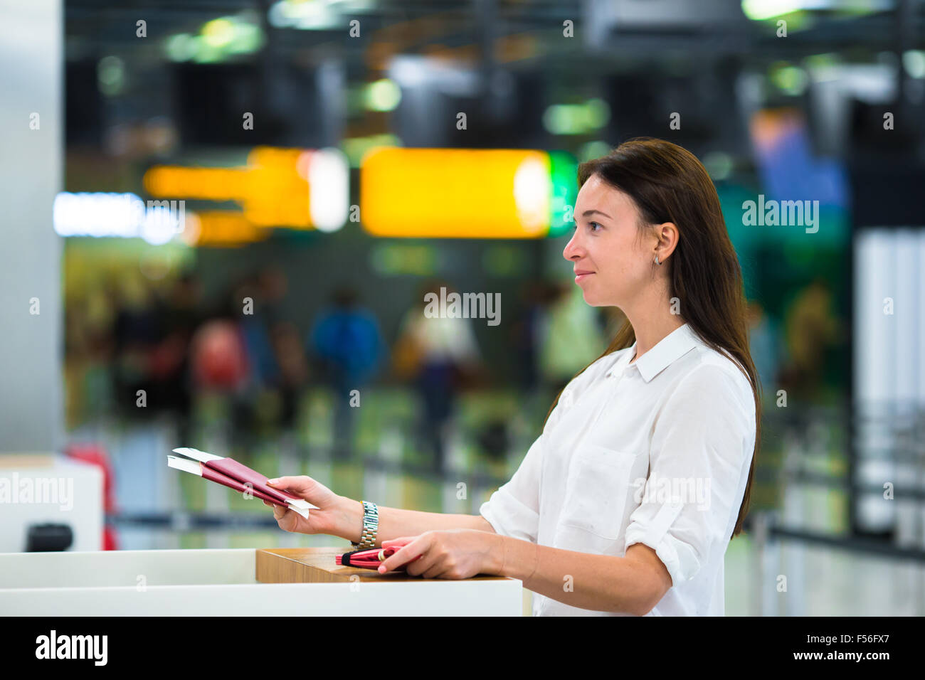 Woman With Passports And Boarding Passes At The Front Desk At