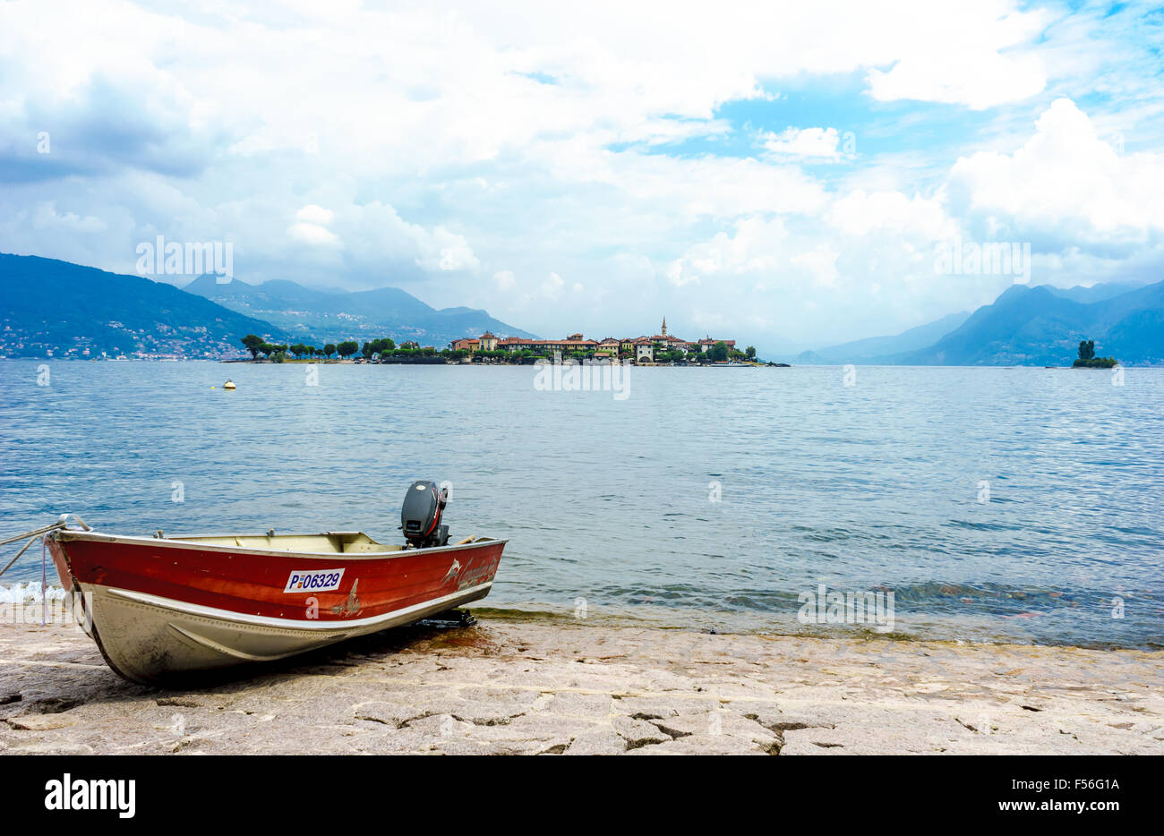 A boat docks in front of Isola Pescatori on Lake Maggiore in summer. Stock Photo