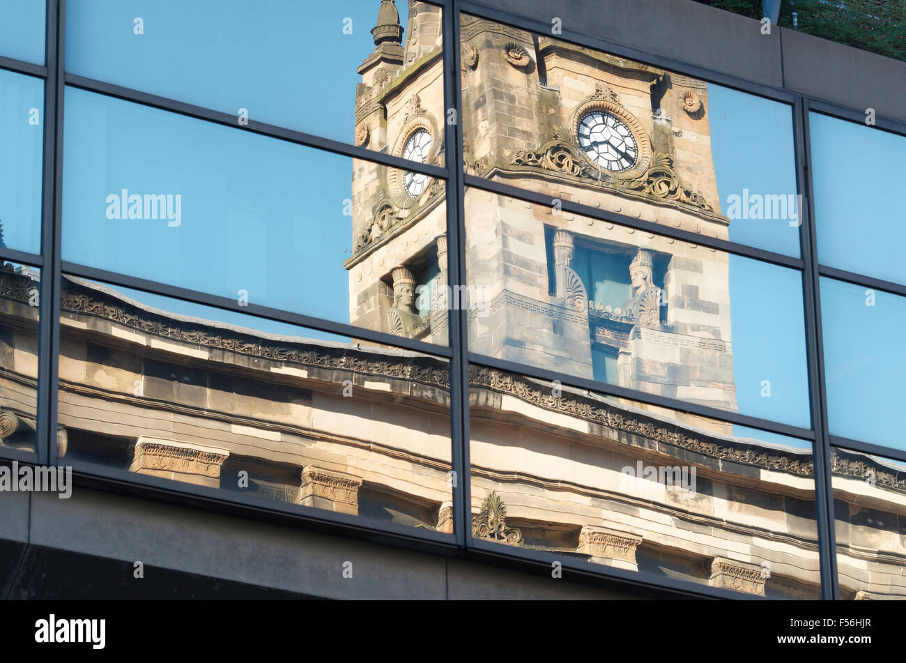 Clock Tower of the Glasgow City Free Church reflected in windows of the Santander Building. Stock Photo