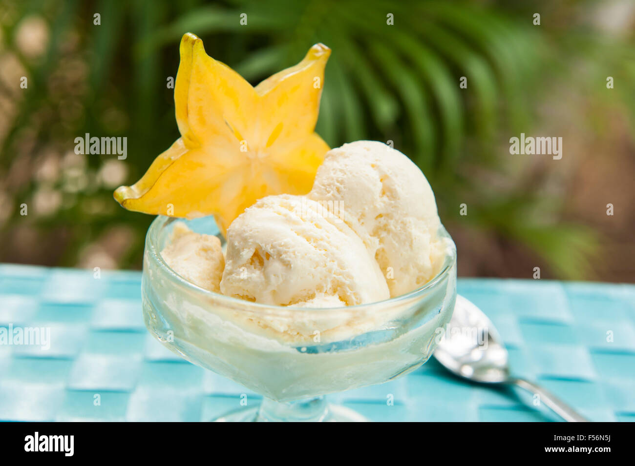 Dish of starfruit ice cream with a slice of starfruit outdoors Stock Photo