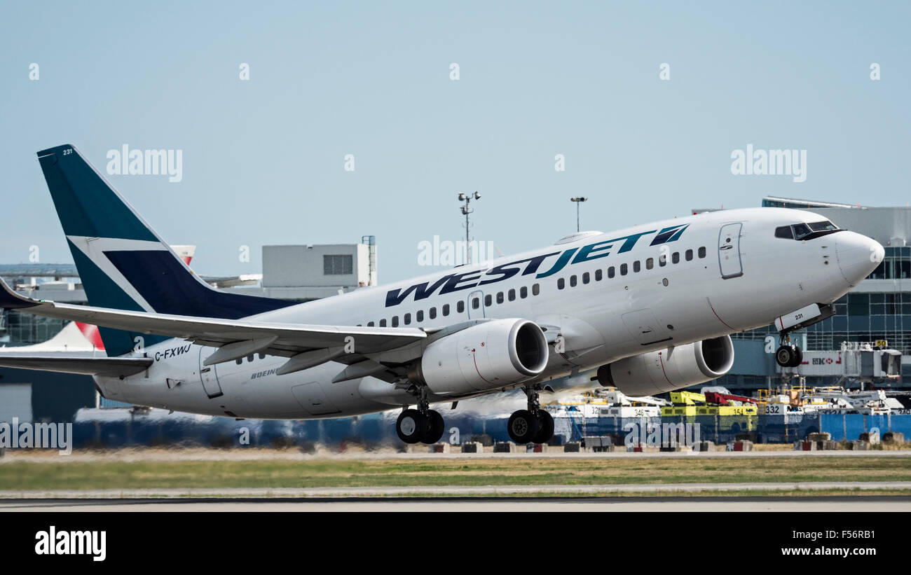 WestJet Airlines Boeing 737-700 C-FXWJ takes taking off airborne Vancouver International Airport Canada Stock Photo