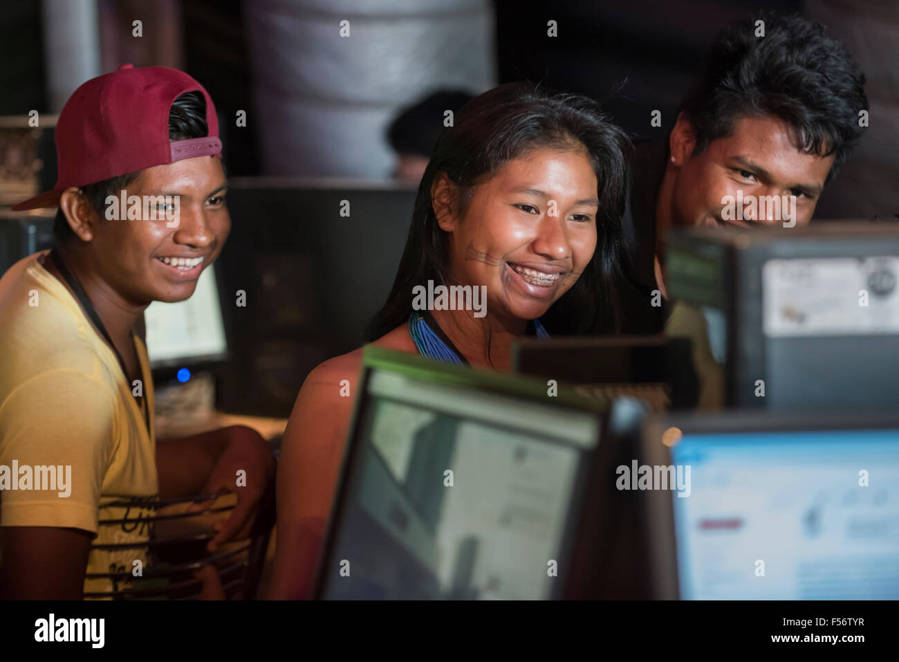 Palmas, Brazil. 28th Oct, 2015. Three young indigenous people share a funny Facebook post in the Digital House at the International Indigenous Games, in the city of Palmas, Tocantins State, Brazil. Credit:  Sue Cunningham Photographic/Alamy Live News Stock Photo