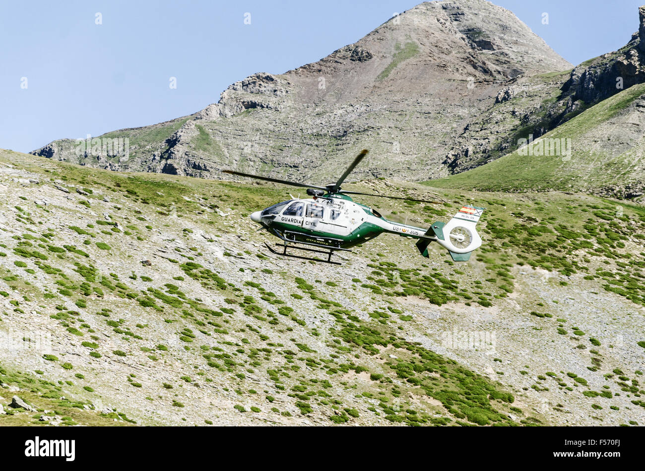 Chopper of Guardia civil patrulling over the mountain in Spain Stock Photo
