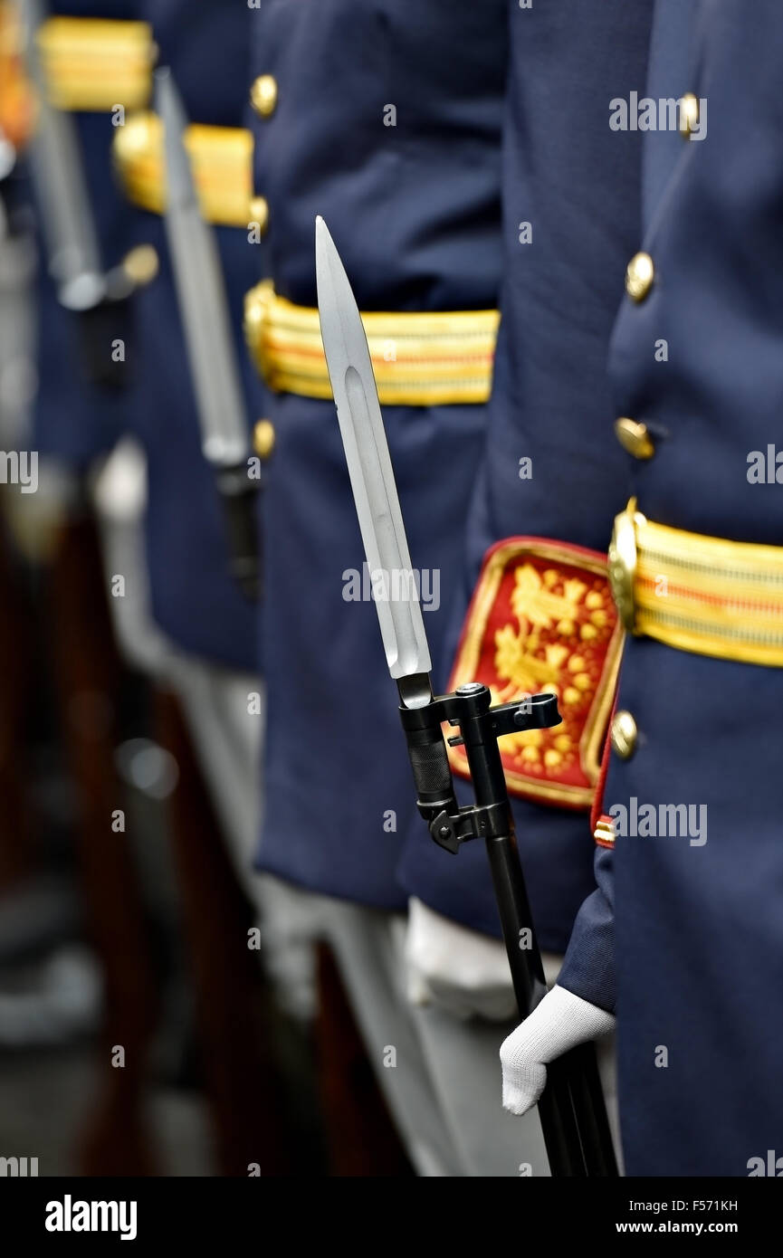 Detail with the hand of a soldier on a bayonet rifle in rest position during a military parade Stock Photo