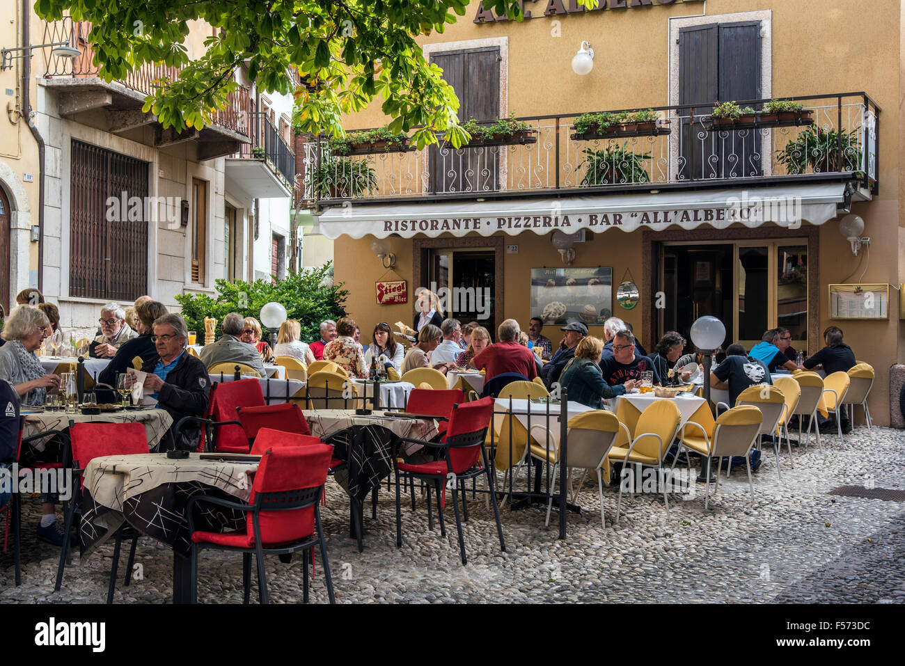 Outdoor cafe restaurant in Malcesine, Lake Garda, Veneto, Italy Stock Photo