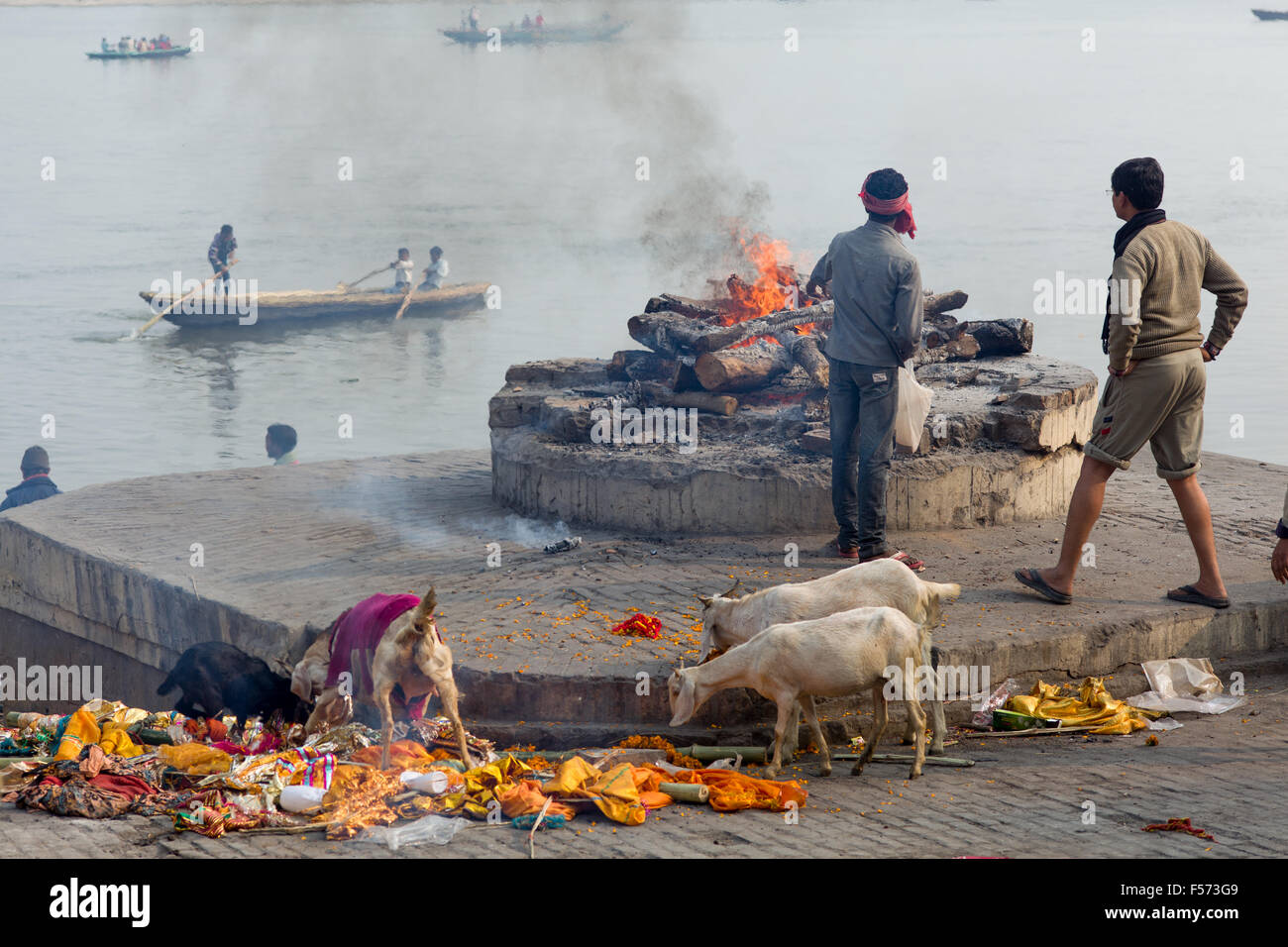 Hinduistic ritual cremation on a fire place at the Assi Ghat of the ...