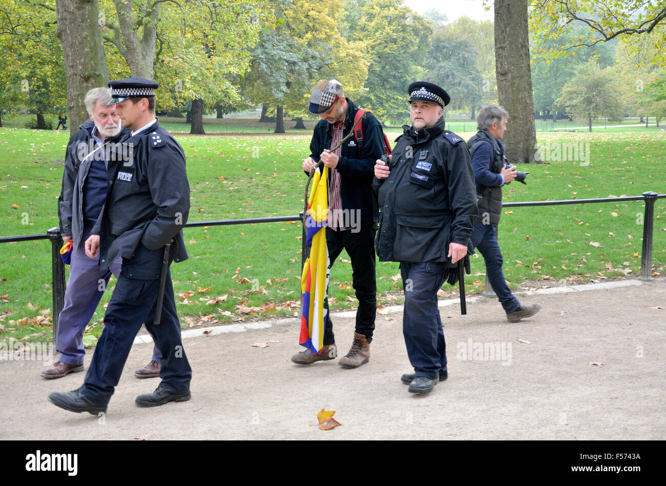London. A protester with a Tibetan flag is led away by police before Chinese President Xi Jinping passes in the Mall - Oct 2015 Stock Photo