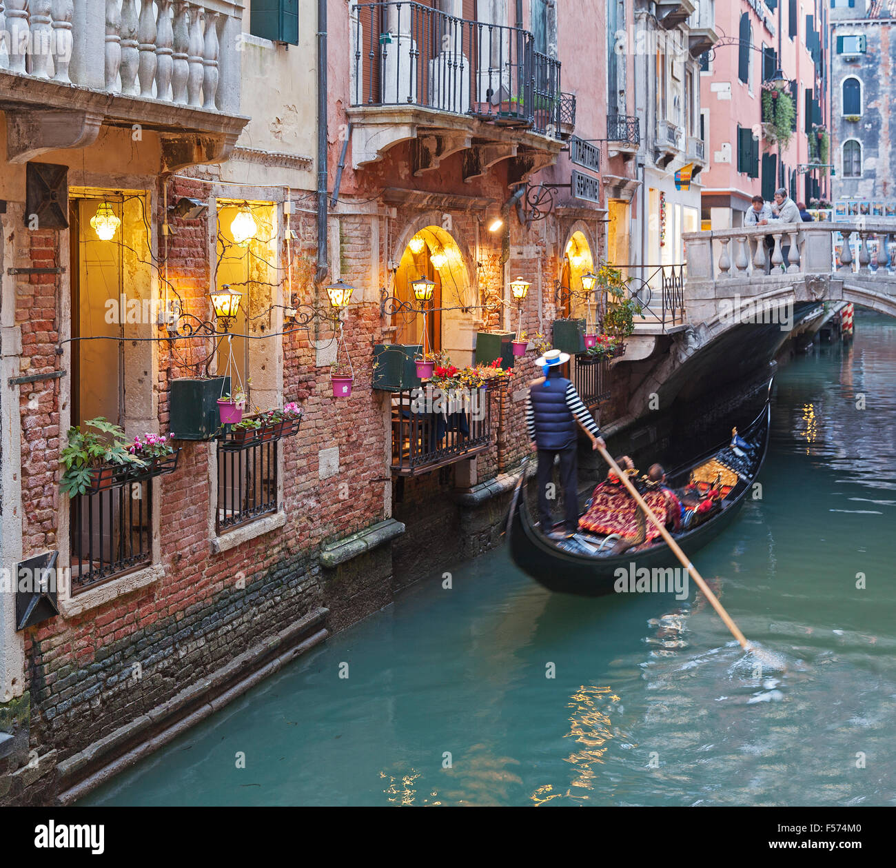 Venice canal with gondola in evening - Italy Stock Photo