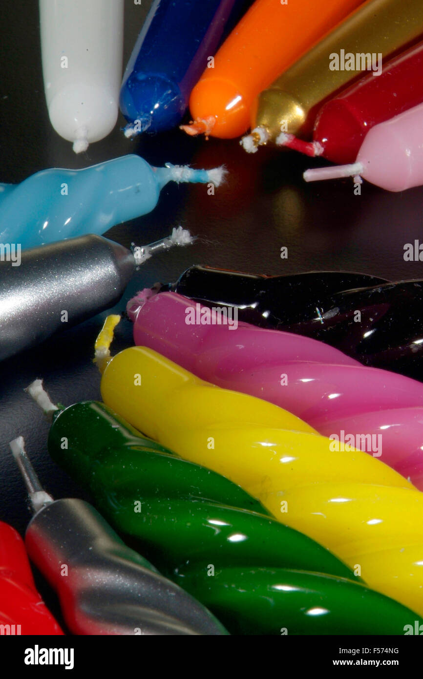 Group of colorful candles on a black background Stock Photo - Alamy