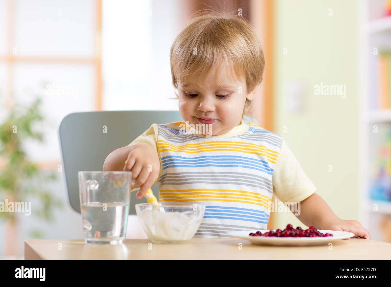 kid eating healthy food at nursery room Stock Photo