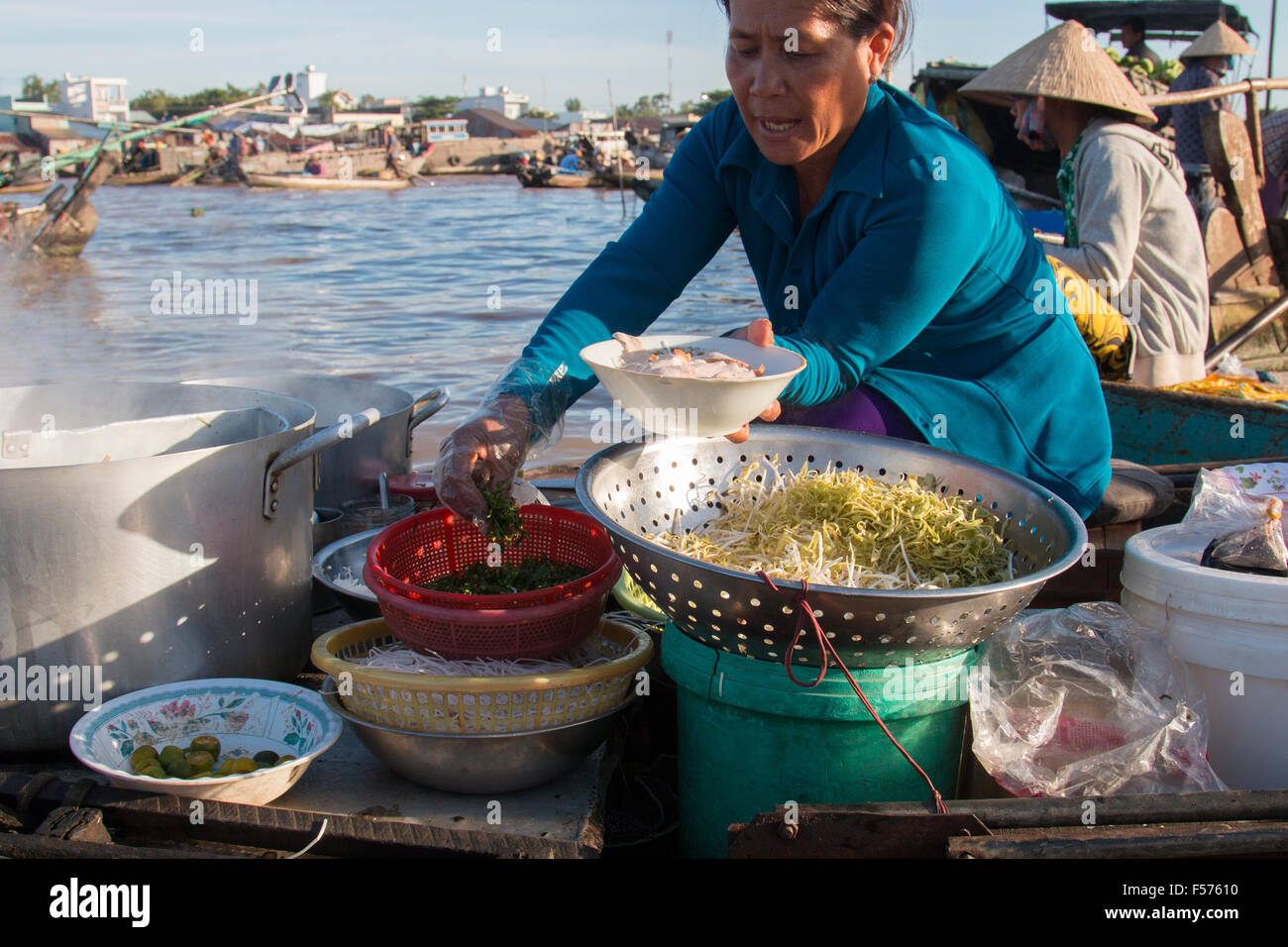 mature vietnamese lady preparing breakfast Pho at the floating markets Mekong Delta,Can Tho,Vietnam Stock Photo