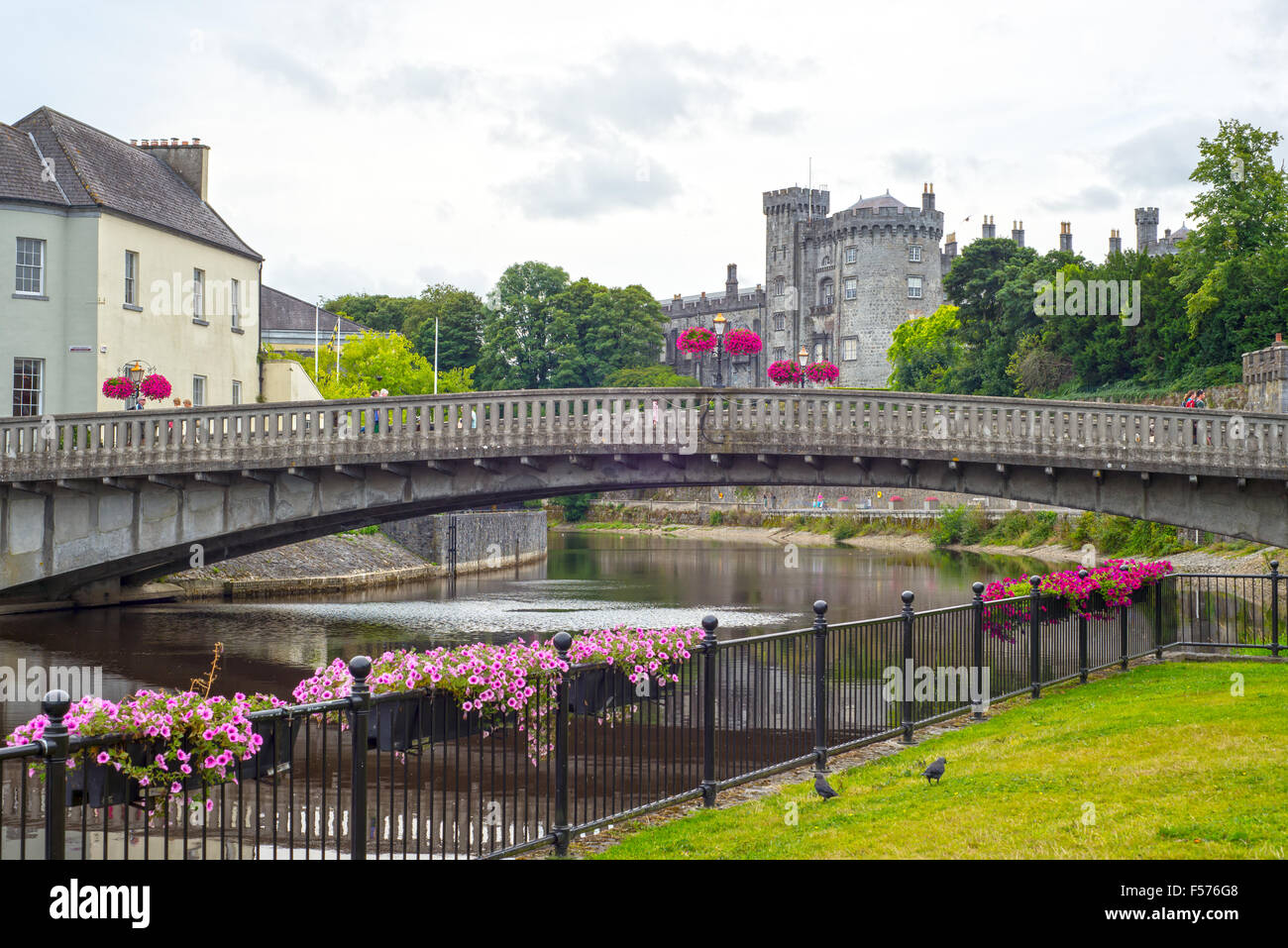 beautiful flower lined riverside railings view of kilkenny castle town and bridge Stock Photo