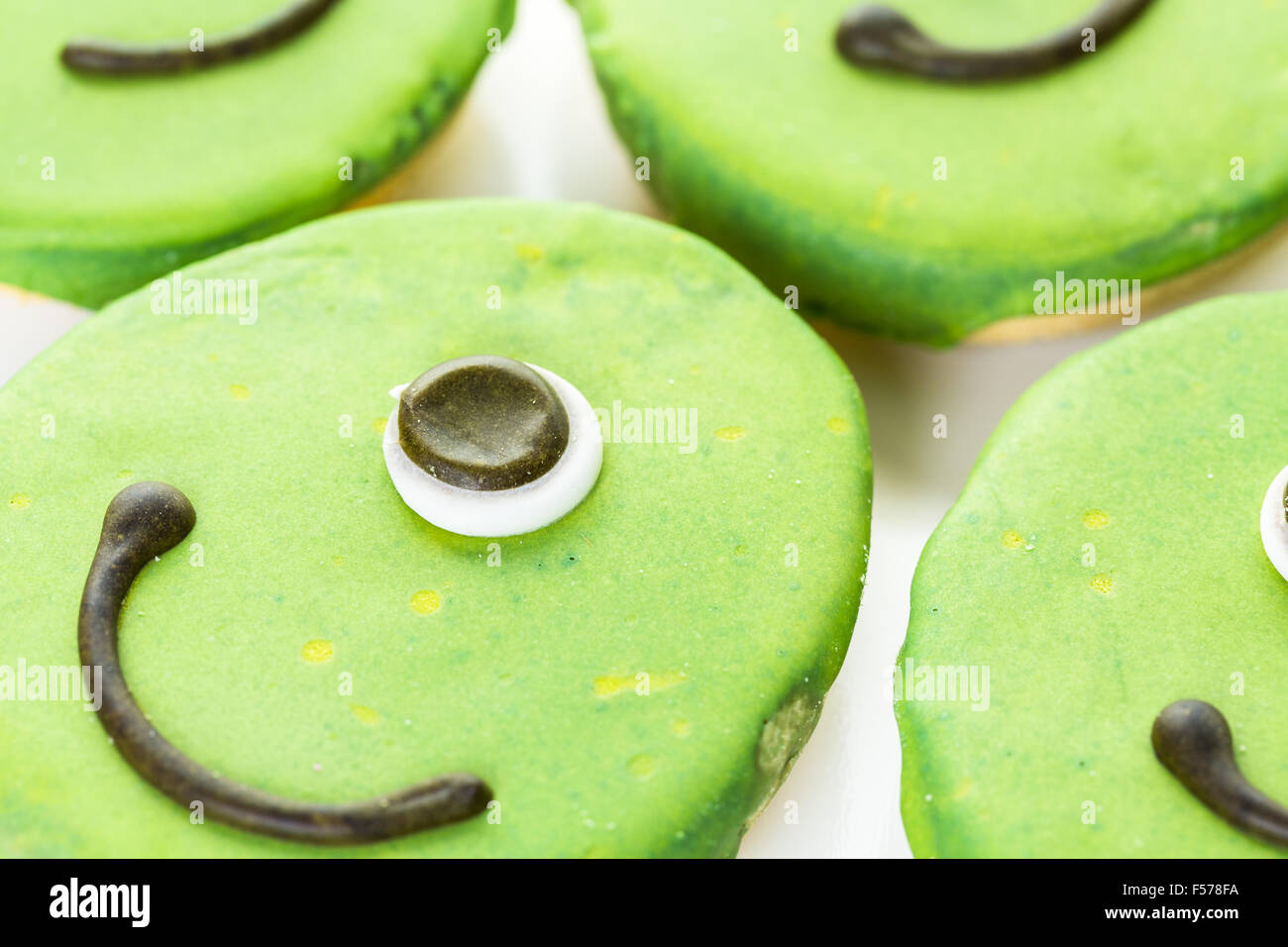 Alien cookies with green icing prepared as Halloween treats Stock Photo ...