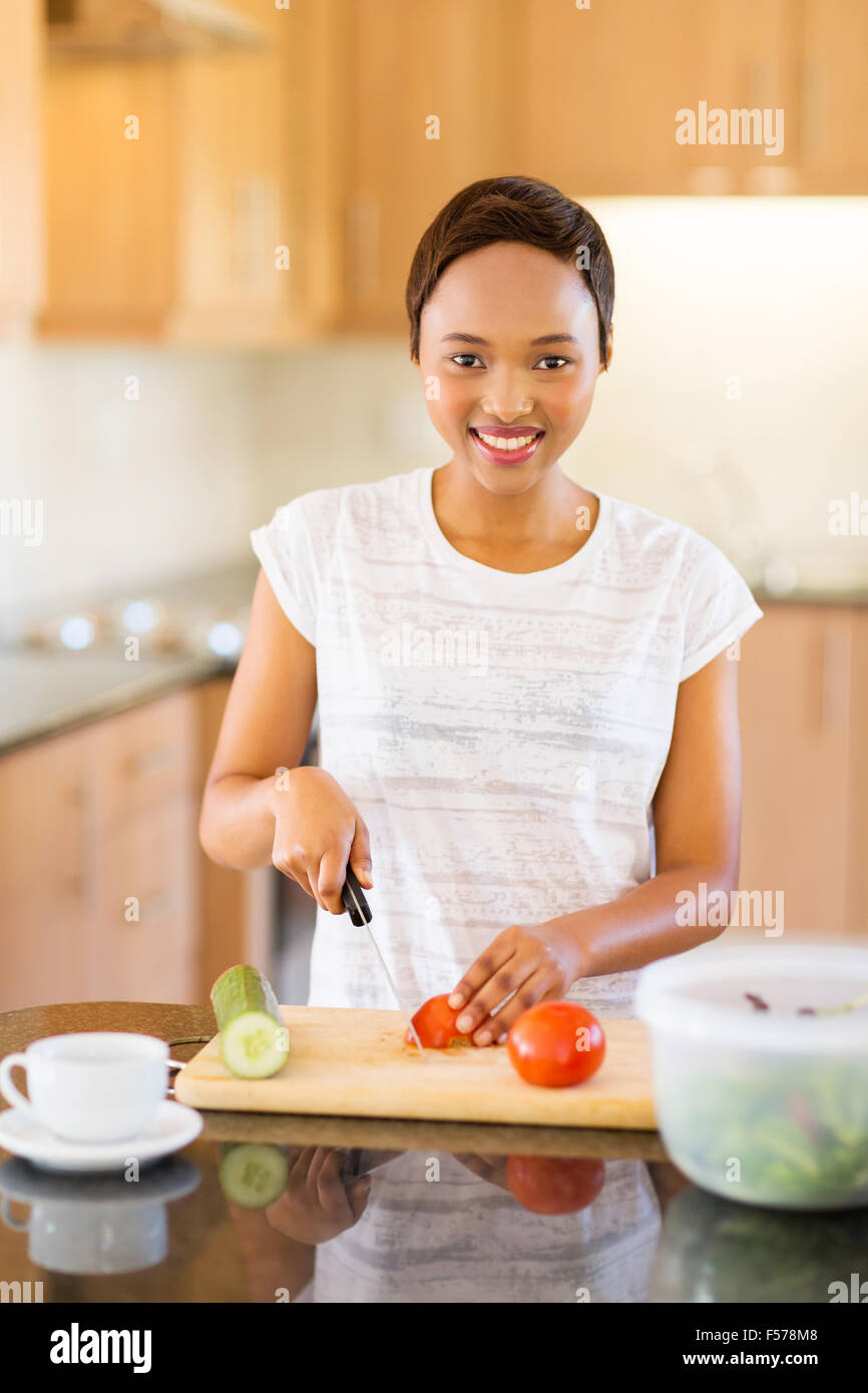 cheerful African American girl cooking diner Stock Photo - Alamy