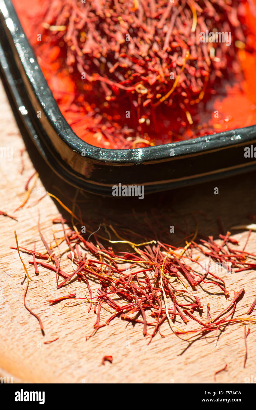 Saffron in a red laquer box. Close up of spice. Concept of culinary cooking. Stock Photo