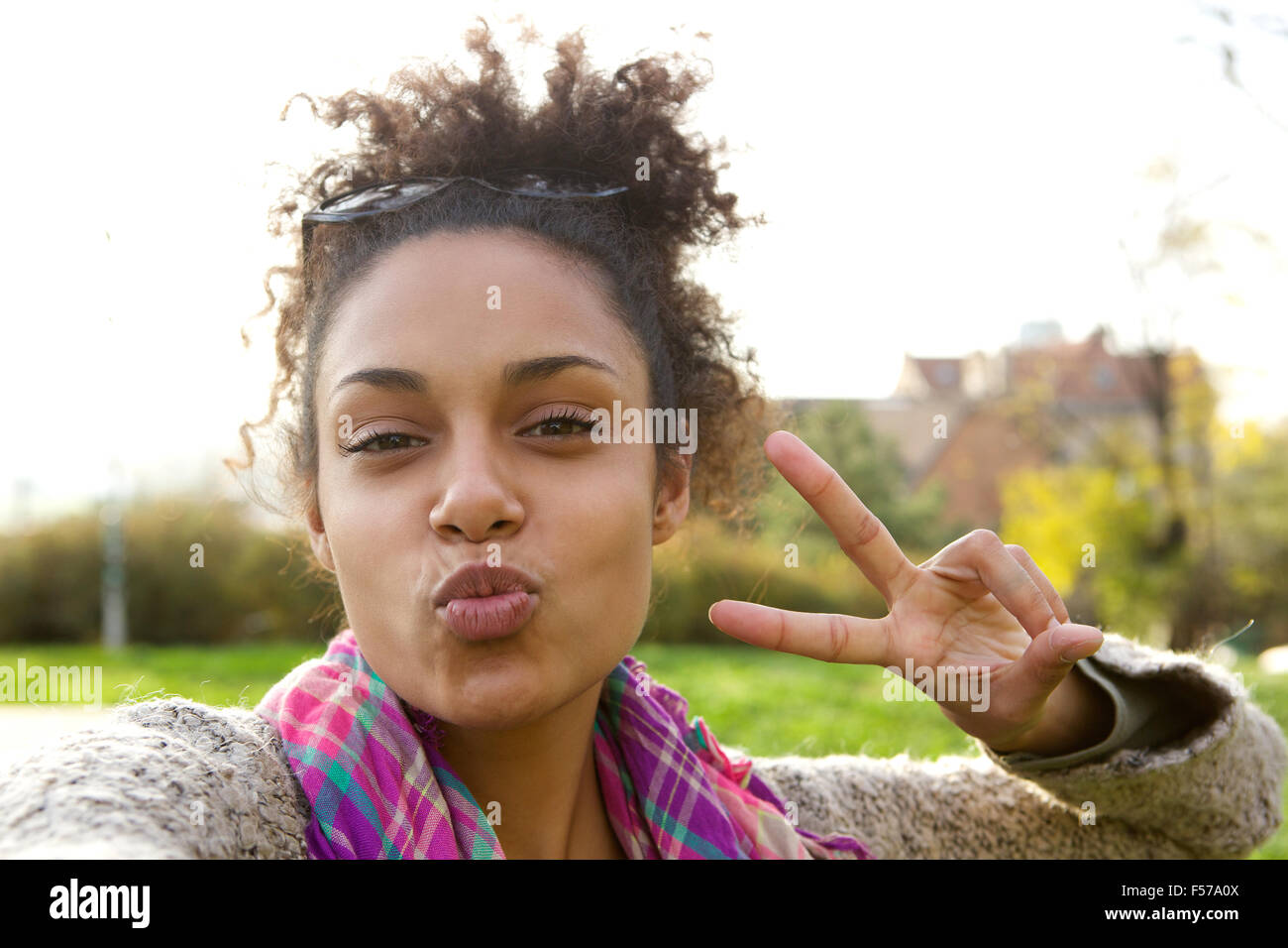 Selfie portrait of a cute girl making fun face with peace sign Stock Photo  - Alamy, image size:1300x956