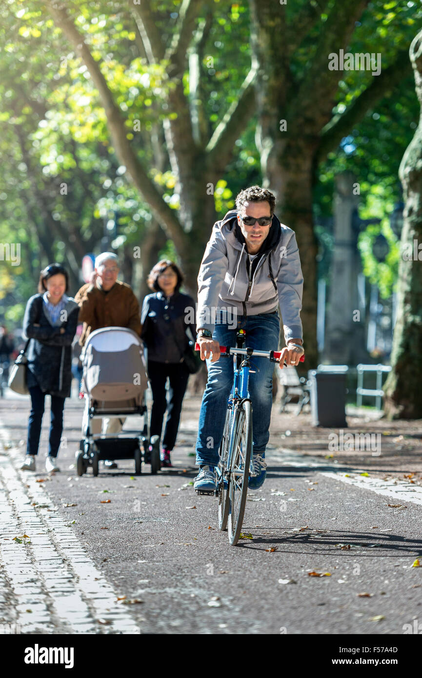 Cyclist across the Königsalee in Düsseldorf on a sunny day (MR) Stock Photo