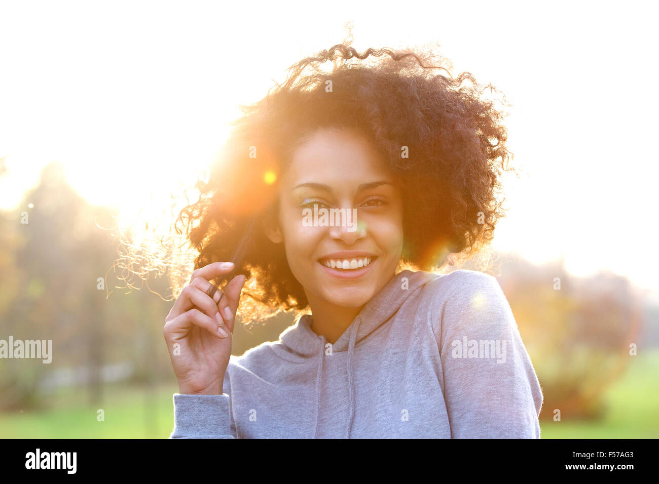 Close up portrait of a smiling young black woman with curly hair Stock ...