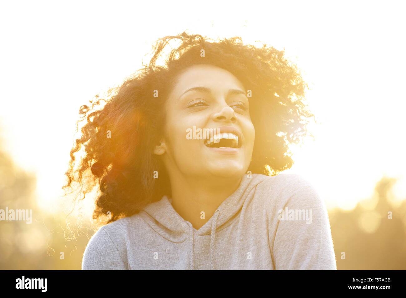 Close up portrait of a happy african american girl laughing outdoors ...