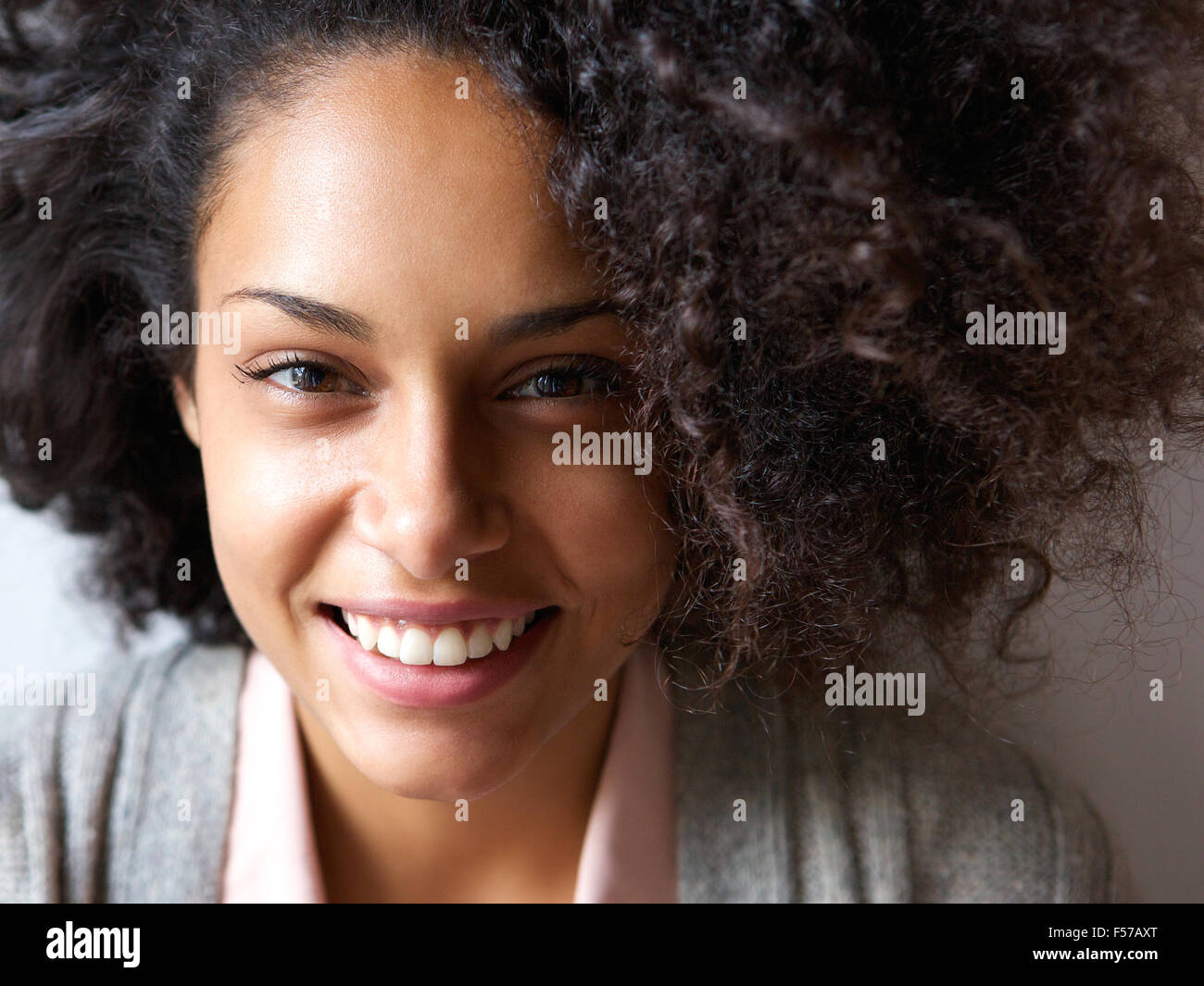 Close up portrait of a beautiful young african american woman smiling ...