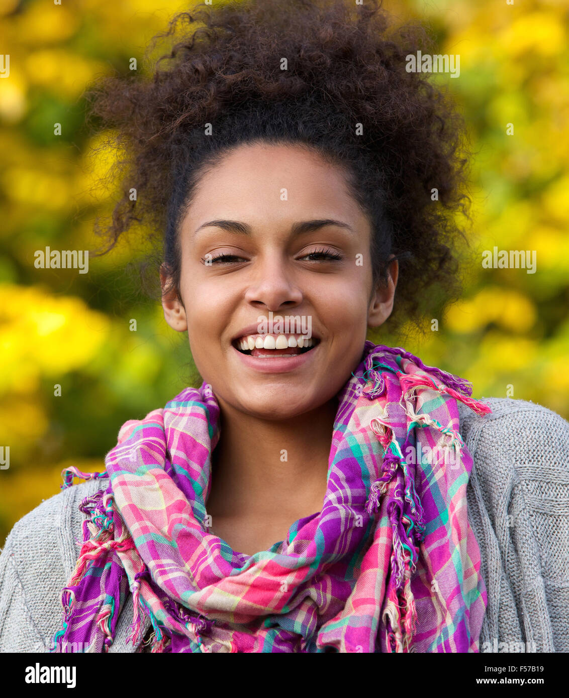 Close up portrait of a happy african american woman laughing outside ...
