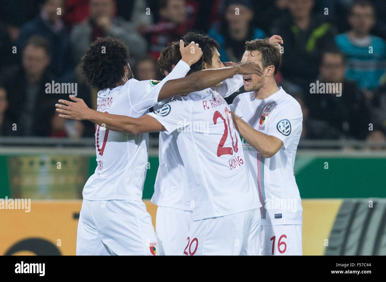 Augsburg's Caiuby (L-R), Dong-Won Ji, Jeong-Ho Hong and Christoph Janker celebrate the 1-0 goal during the DFB Cup match between SC Freiburg and FC Augsburg in the Schwarzwald Stadium in Freiburg, Germany, 28 October 2015. Photo: PATRICL SEEGER/dpa Stock Photo