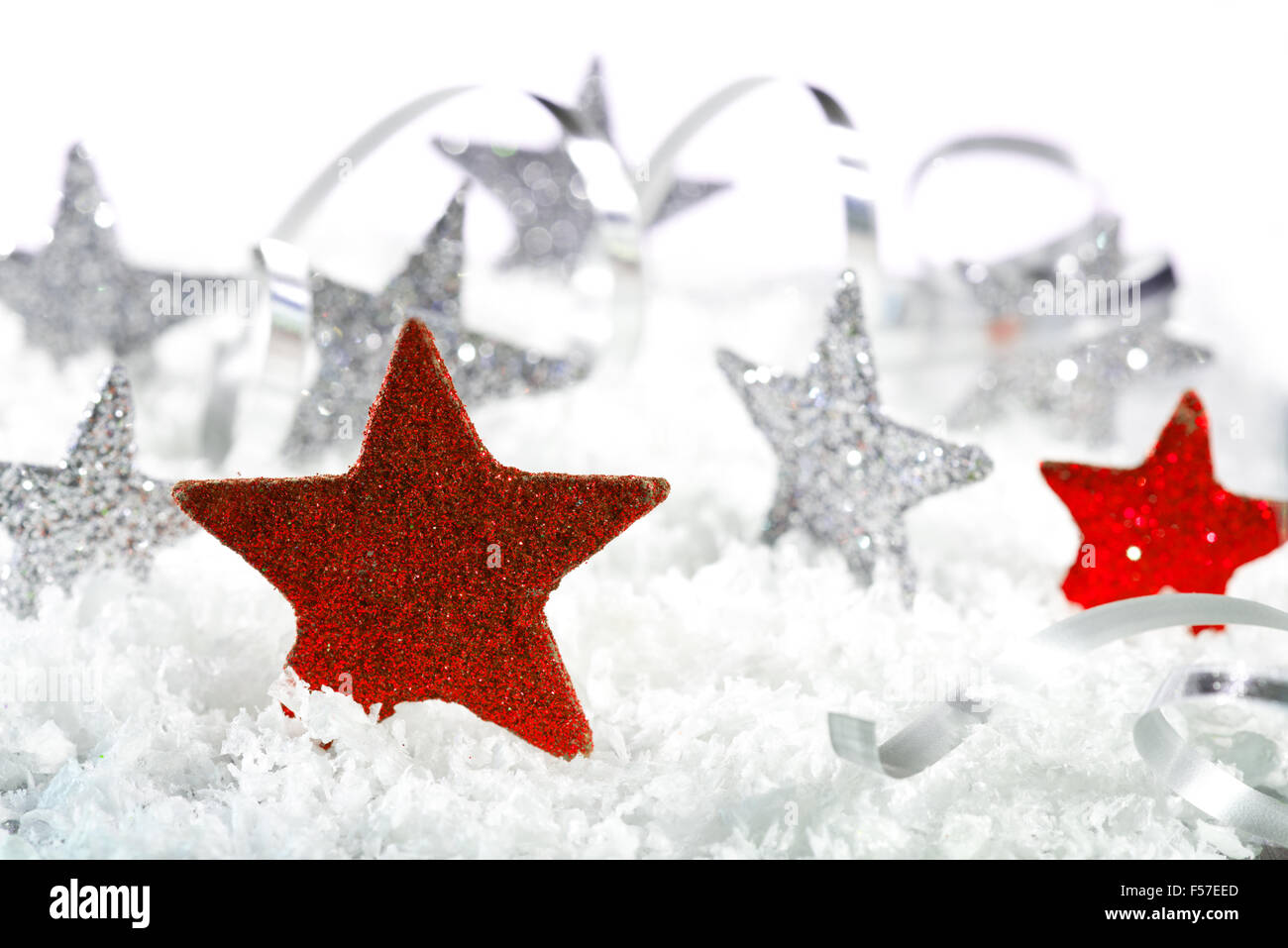 Red Christmas star with silver stars on the snow Stock Photo