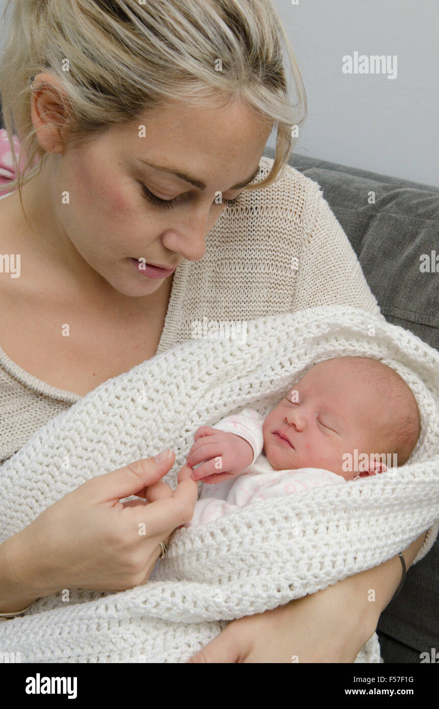 Mother and one day old girl back home from hospital birth. UK. Stock Photo