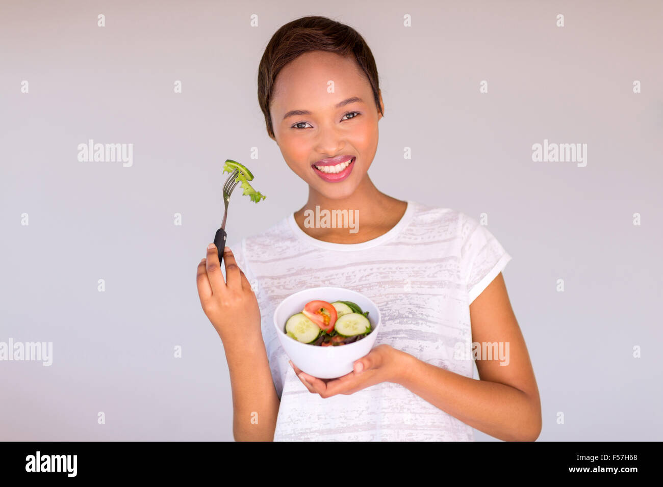 gorgeous African vegetarian eating salad at home Stock Photo