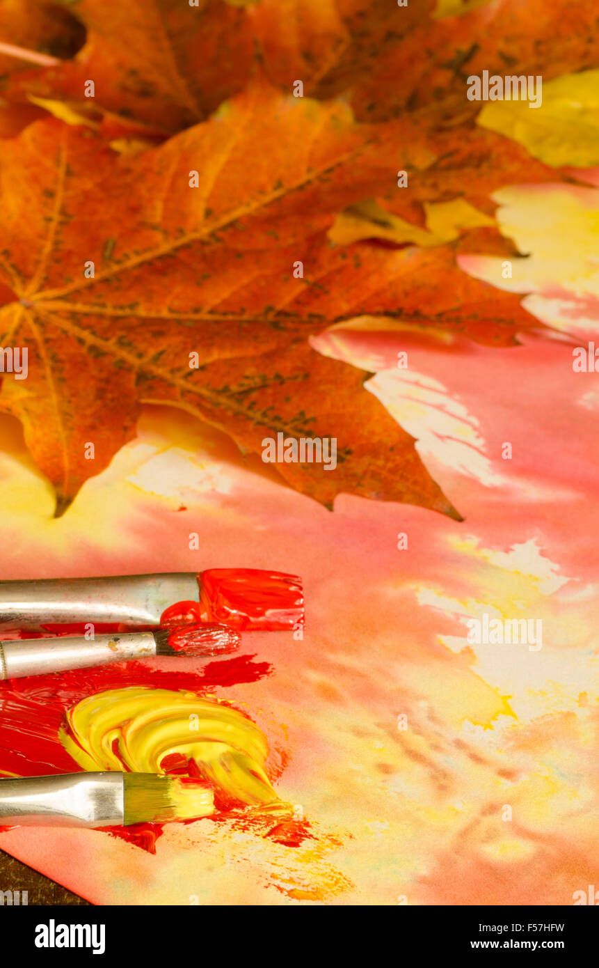 painting fall leaves with watercolor paints Stock Photo