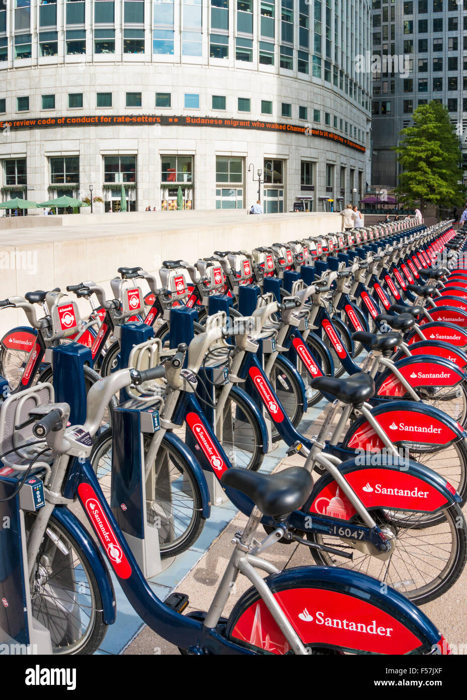 Santander red Boris Bikes for hire in a docking station Canary Wharf London England UK GB EU Europe Stock Photo