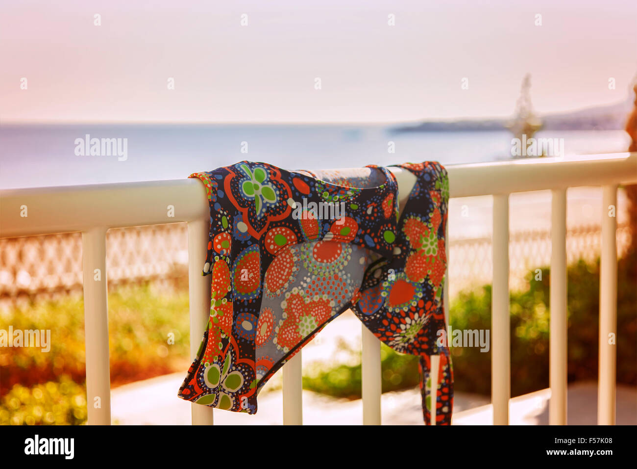 Image of a bikini hanging over a vacation balcony. Stock Photo